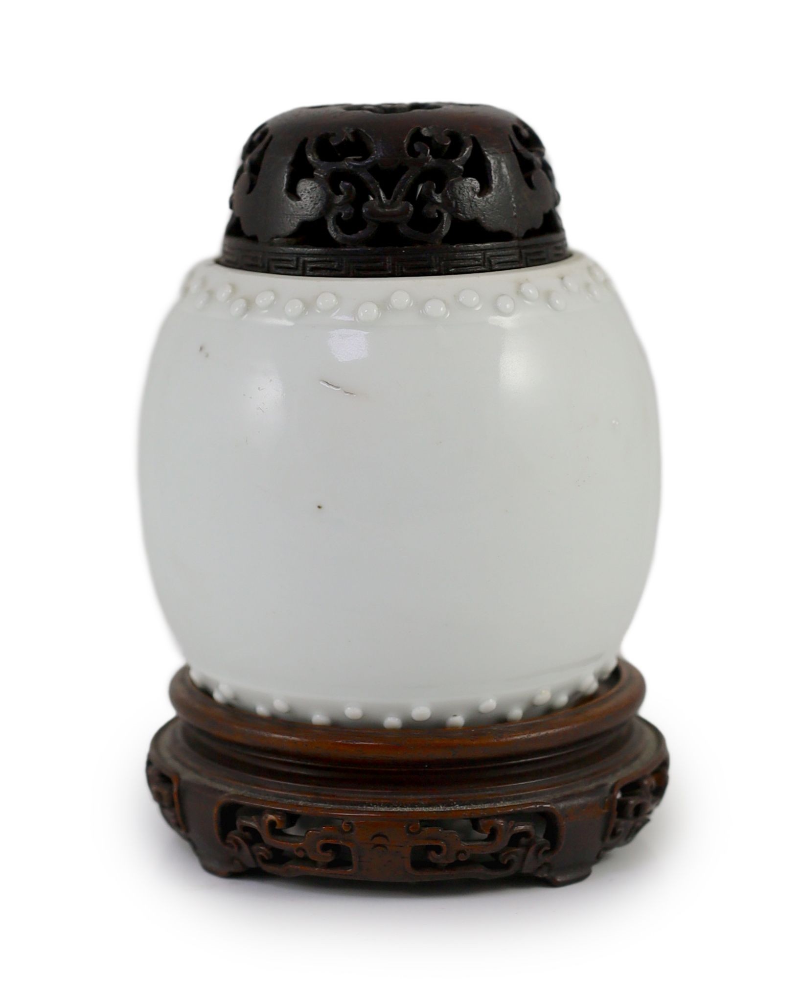 A Chinese blanc-de-chine jar, Dehua kilns, Kangxi period, 8cm high excluding wood cover and stand